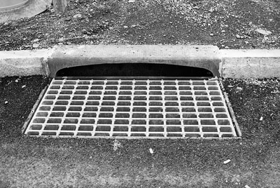 Photo. This photo shows a grate with criss-crossed bars to allow a bicycle to traverse it safety.