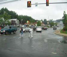 Pedestrians crossing at signalized intersection without designated crosswalk.